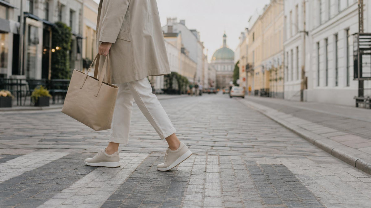 Kvinde går gennem en europæisk storby iført lette, komfortable sneakers